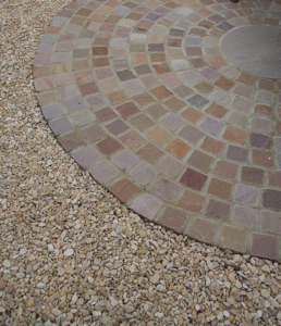 Gravel next to seating area laid with sandstone setts