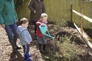 The children helping with the watering during planting