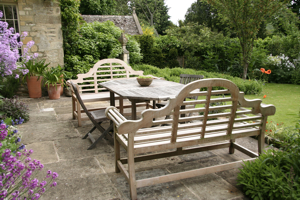 Classic garden furniture on the terrace creates a comfortable outdoor dining area