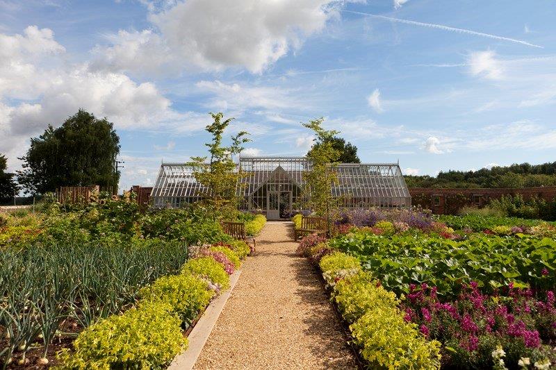 A bespoke greenhouse in an extensive walled garden