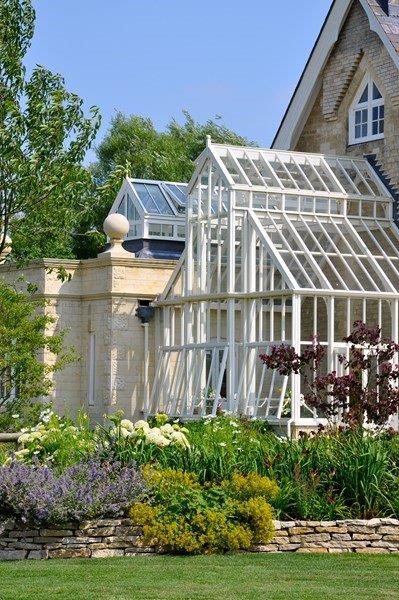 A bespoke double height greenhouse attached to the house