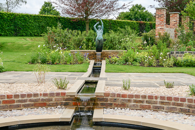 A rill runs through the terrace, between the raised and sunken pools